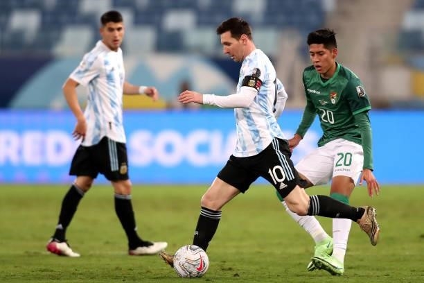 Lionel Messi of Argentina fights for the ball with Ramiro Vaca of Bolivia during a Group A match between Argentina and Bolivia as part of Copa...