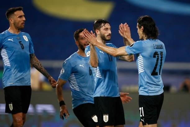 Edinson Cavani of Uruguay celebrates with teammate Matias Viña after scoring the first goal of his team during a group A match between Uruguay and...