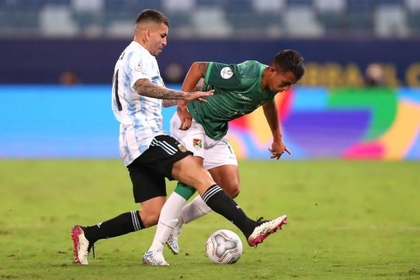 Roberto Fernandez of Bolivia fights for the ball with Angel Correa of Argentina during a Group A match between Argentina and Bolivia as part of Copa...