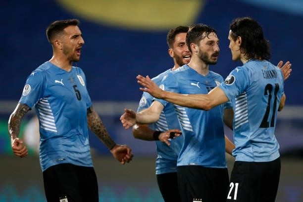 Edinson Cavani of Uruguay celebrates with teammates Matias Viña and Matias Vecino after scoring the first goal of his team during a group A match...