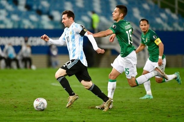 Lionel Messi of Argentina controls the ball against Boris Cespedes of Bolivia during a Group A match between Argentina and Bolivia as part of Copa...