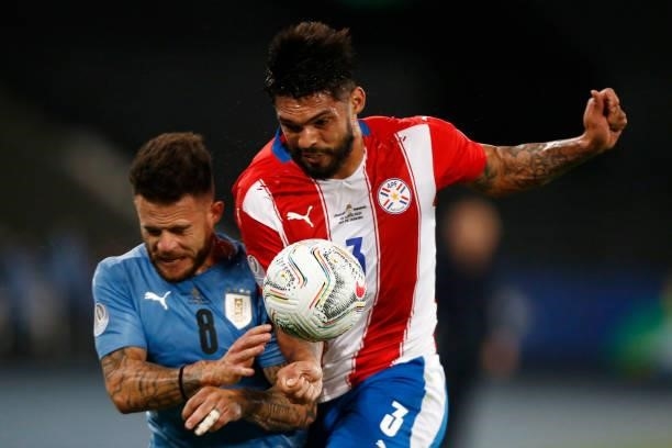 Nahitan Nandez of Uruguay competes for the ball with Omar Alderete of Paraguay during a group A match between Uruguay and Paraguay as part of...