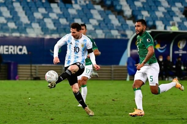 Lionel Messi of Argentina kicks the ball to score the the third goal of his team during a Group A match between Argentina and Bolivia as part of Copa...