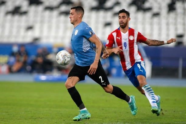 Jose Gimenez of Uruguay competes for the ball with Gabriel Avalos of Paraguay during a group A match between Uruguay and Paraguay as part of Conmebol...