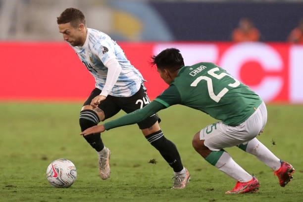 Alejandro Gomez of Argentina fights for the ball with Jeyson Chura of Bolivia during a Group A match between Argentina and Bolivia as part of Copa...