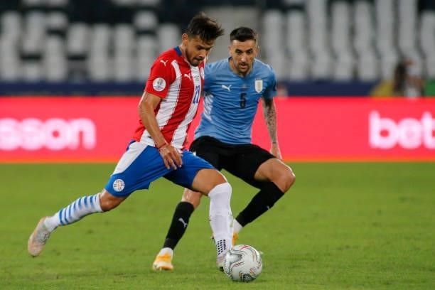 Oscar Romero of Paraguay competes for the ball with Matias Vecino of Uruguay during a group A match between Uruguay and Paraguay as part of Conmebol...