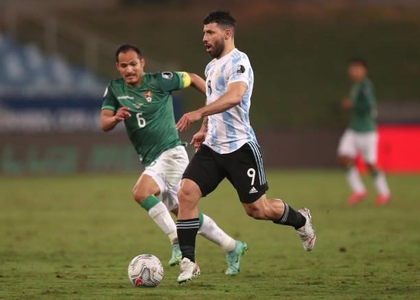 Sergio Agüero of Argentina controls the ball against Leonel Justiniano of Bolivia during a Group A match between Argentina and Bolivia as part of...