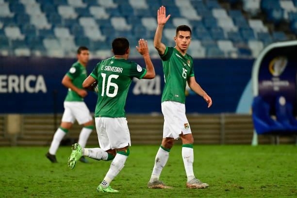 Erwin Saavedra of Bolivia celebrates with teammate Boris Cespedes of Bolivia after scoring the first goal of his team during a Group A match between...