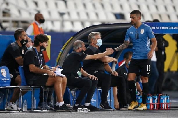 Giorgian De Arrascaeta of Uruguay greets his head coach Oscar Tabarez after being replaced during a group A match between Uruguay and Paraguay as...