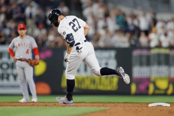 Giancarlo Stanton of the New York Yankees rounds the bases after hitting a solo home run during the sixth inning against the Los Angeles Angels at...