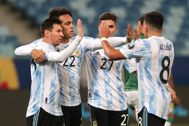 Lautaro Martinez of Argentina celebrates with teammates after scoring the fourth goal of his team during a Group A match between Argentina and...