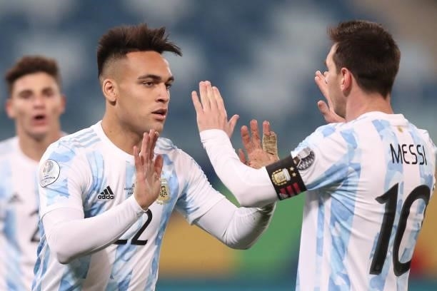 Lautaro Martinez of Argentina celebrates with teammate Lionel Messi after scoring the fourth goal of his team during a Group A match between...