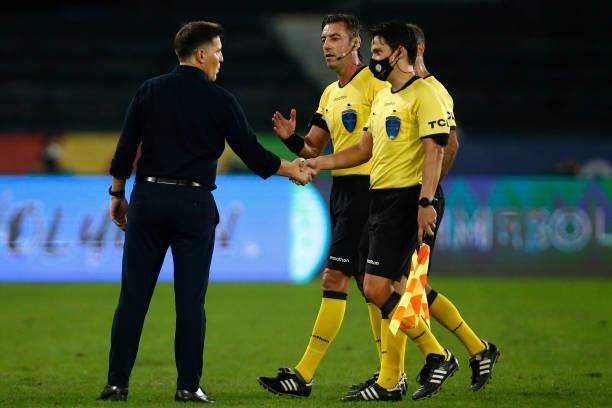 Eduardo Berizzo head coach of Paraguay greets referee Raphael Claus and his assistants after a group A match between Uruguay and Paraguay as part of...