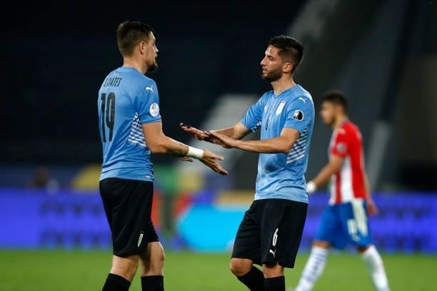 Sebastian Coates of Uruguay greets teammate Rodrigo Bentancur after winning a group A match between Uruguay and Paraguay as part of Conmebol Copa...