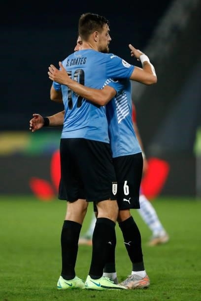 Sebastian Coates of Uruguay hugs teammate Rodrigo Bentancur after winning a group A match between Uruguay and Paraguay as part of Conmebol Copa...
