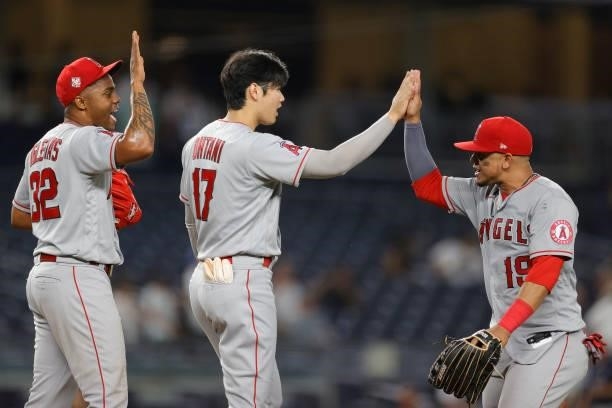 Raisel Iglesias, Shohei Ohtani, and Juan Lagares of the Los Angeles Angels celebrate their win during the ninth inning against the New York Yankees...