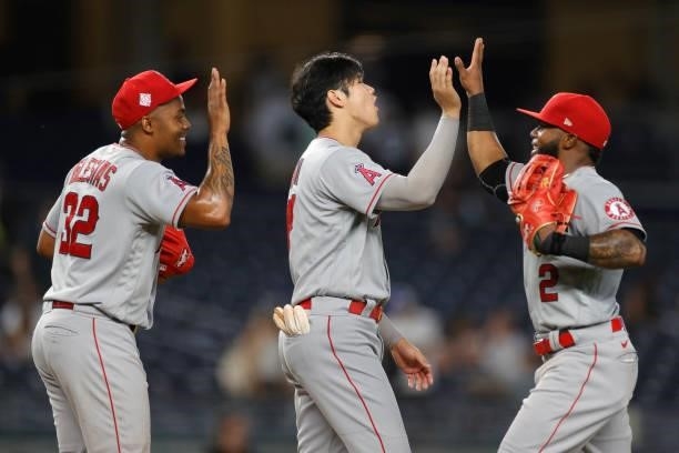 Raisel Iglesias, Shohei Ohtani, and Luis Rengifo of the Los Angeles Angels celebrate their win during the ninth inning against the New York Yankees...