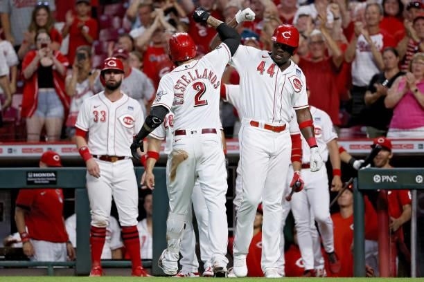 Nick Castellanos and Aristides Aquino of the Cincinnati Reds celebrate after Castellanos hit a grand slam in the seventh inning against the...