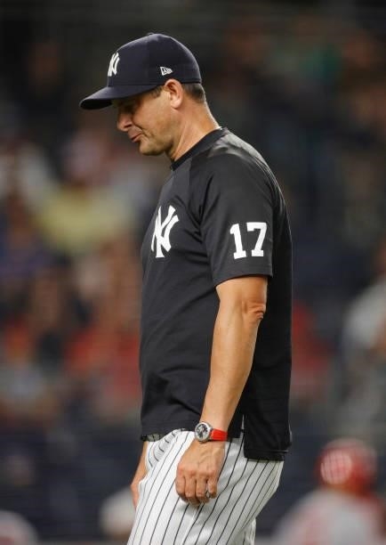 Manager Aaron Boone of the New York Yankees looks on as he walks back to the dugout during the sixth inning against the Los Angeles Angels at Yankee...