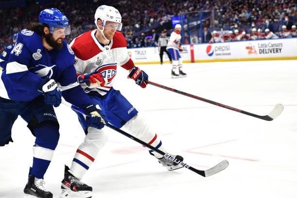 Pat Maroon of the Tampa Bay Lightning battles with Corey Perry of the Montreal Canadiens during the third period of Game One of the 2021 Stanley Cup...