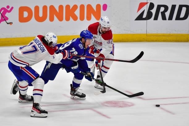 Ross Colton of the Tampa Bay Lightning is defended by Josh Anderson and Erik Gustafsson of the Montreal Canadiens during the third period in Game One...