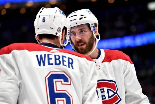 Joel Edmundson and Shea Weber of the Montreal Canadiens chat while playing against the Tampa Bay Lightning during the second period of Game One of...