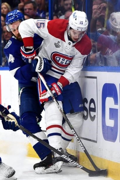 Jesperi Kotkaniemi of the Montreal Canadiens is pressured by Jan Rutta of the Tampa Bay Lightning at the boards during the second period of Game One...