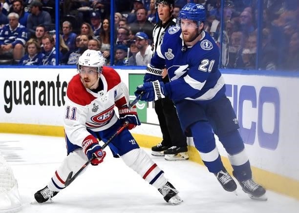Brendan Gallagher of the Montreal Canadiens and Blake Coleman of the Tampa Bay Lightning battle behind the net during the second period of Game One...