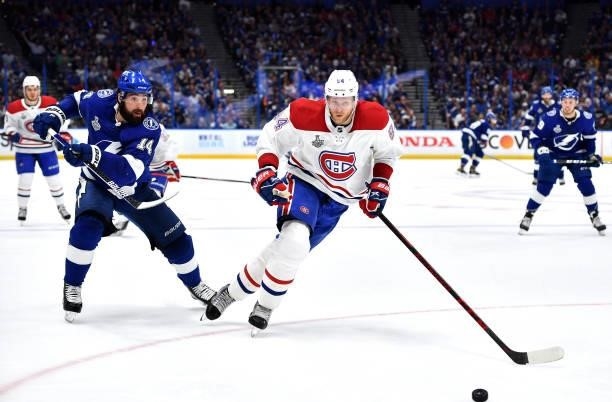 Corey Perry of the Montreal Canadiens is chased by Pat Maroon of the Tampa Bay Lightning during the third period of Game One of the 2021 Stanley Cup...