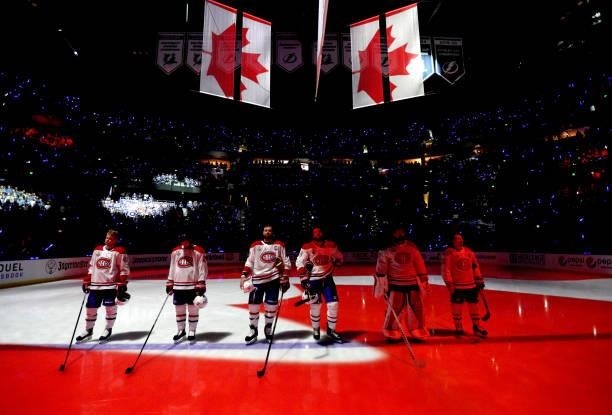 The starting line up for the Montreal Canadiens stand on the ice during the singing of the Canadian national anthem before Game One of the 2021...