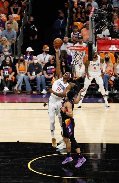 Terance Mann of the LA Clippers puts up a shot over Devin Booker of the Phoenix Suns during the first half of game five of the Western Conference...