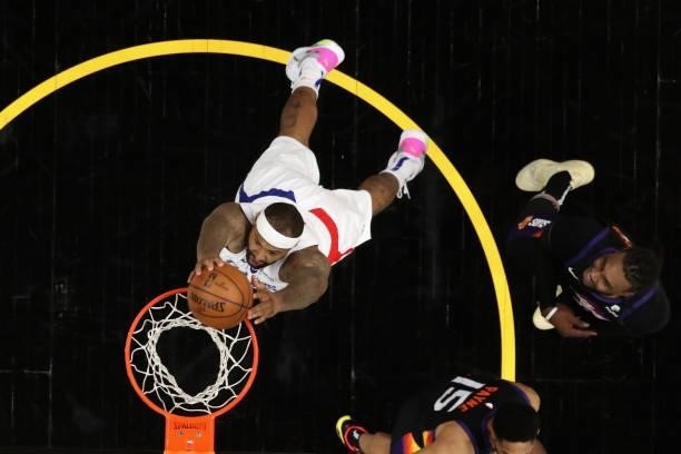 DeMarcus Cousins of the LA Clippers slam dunks ahead of Jae Crowder of the Phoenix Suns during the first half of game five of the Western Conference...