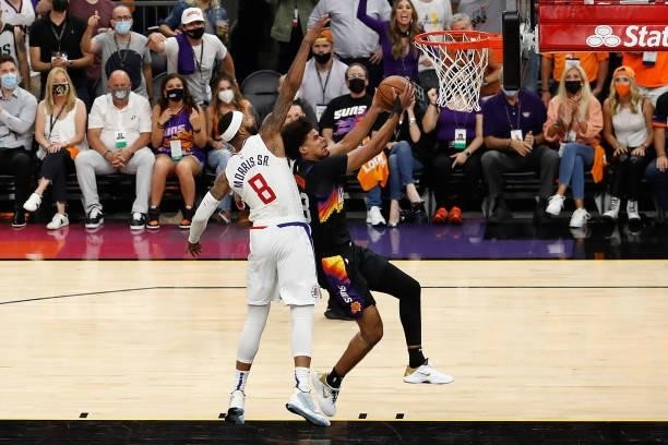 Cameron Johnson of the Phoenix Suns lays up a shot past Marcus Morris Sr. #8 of the LA Clippers during the second half of game five of the Western...