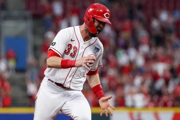 Jesse Winker of the Cincinnati Reds reacts while rounding the base after Nick Castellanos hit a grand slam in the seventh inning against the...