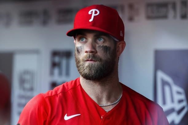 Bryce Harper of the Philadelphia Phillies looks on from the dugout in the fifth inning against the Cincinnati Reds at Great American Ball Park on...