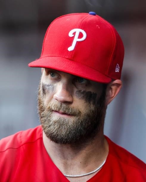 Bryce Harper of the Philadelphia Phillies looks on from the dugout in the fifth inning against the Cincinnati Reds at Great American Ball Park on...