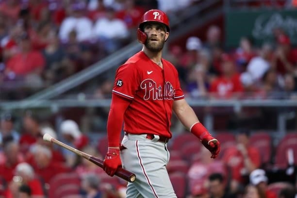 Bryce Harper of the Philadelphia Phillies walks back to the dugout after fouling out in the seventh inning against the Cincinnati Reds at Great...