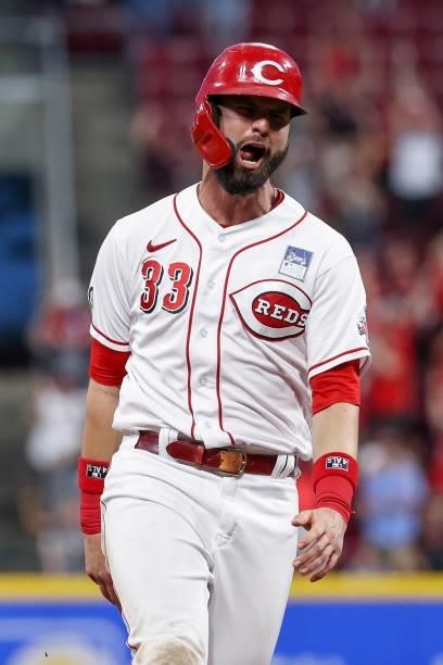Jesse Winker of the Cincinnati Reds reacts while rounding the base after Nick Castellanos hit a grand slam in the seventh inning against the...