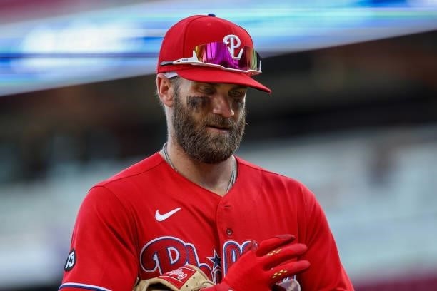 Bryce Harper of the Philadelphia Phillies walks across the field in the third inning against the Cincinnati Reds at Great American Ball Park on June...