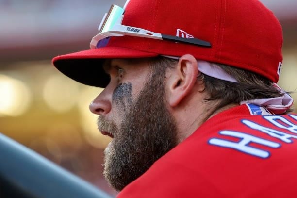 Bryce Harper of the Philadelphia Phillies looks on from the dugout in the fourth inning against the Cincinnati Reds at Great American Ball Park on...