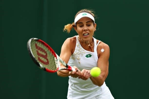 Mihaela Buzarnescu of Romania plays a backhand in her Ladies' Singles First Round match against Venus Williams of United States during Day Two of The...