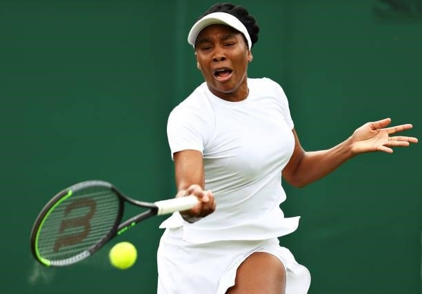 Venus Williams of United States plays a forehand in her Ladies' Singles First Round match against Mihaela Buzarnescu of Romania during Day Two of The...