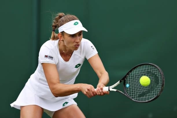 Elise Mertens of Belgium plays a backhand in her Ladies' Singles First Round match against Harriet Dart of Great Britain during Day Two of The...