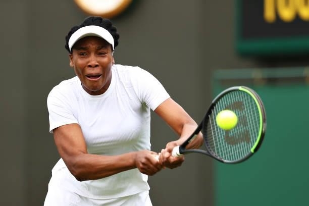 Venus Williams of United States plays a backhand in her Ladies' Singles First Round match against Mihaela Buzarnescu of Romania during Day Two of The...
