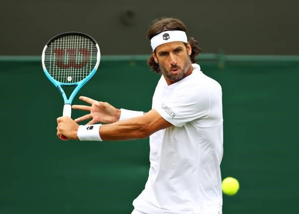 Feliciano Lopez of Spain plays a backhand in his Men's Singles First Round match against Daniel Evans of Great Britain during Day Two of The...