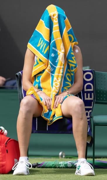 Mihaela Buzarnescu of Romania sits with a towel on her heard ahead of her Ladies' Singles First Round match against Venus Williams of United States...