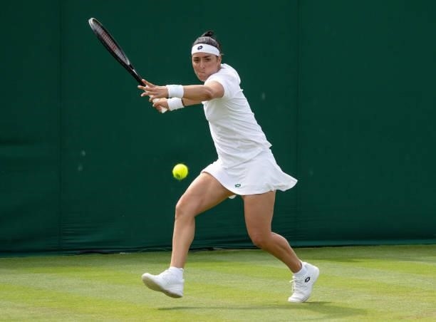 Ons Jabeur of Tunisia plays a forehand in her Ladies' Singles First Round match against Rebecca Peterson of Sweden during Day Two of The...