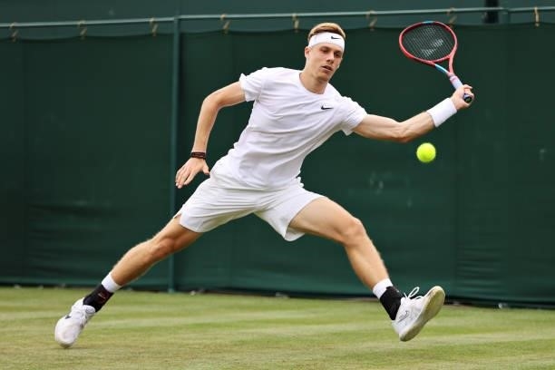 Denis Shapovalov of Canada plays a forehand in his Men's Singles First Round match against Philipp Kohlschreiber of Germany during Day Two of The...
