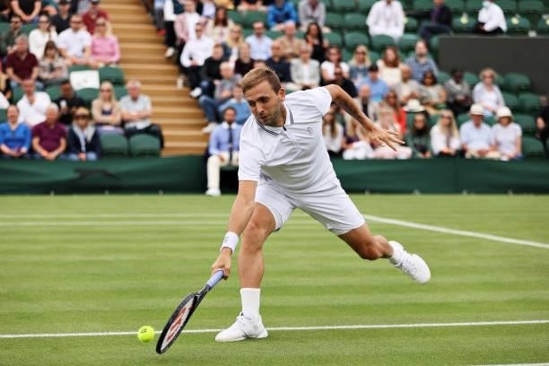 Daniel Evans of Great Britain stretches to play a backhand in his Men's Singles First Round match against Feliciano Lopez of Spain during Day Two of...