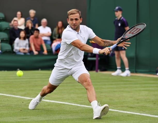 Daniel Evans of Great Britain stretches to play a backhand in his Men's Singles First Round match against Feliciano Lopez of Spain during Day Two of...